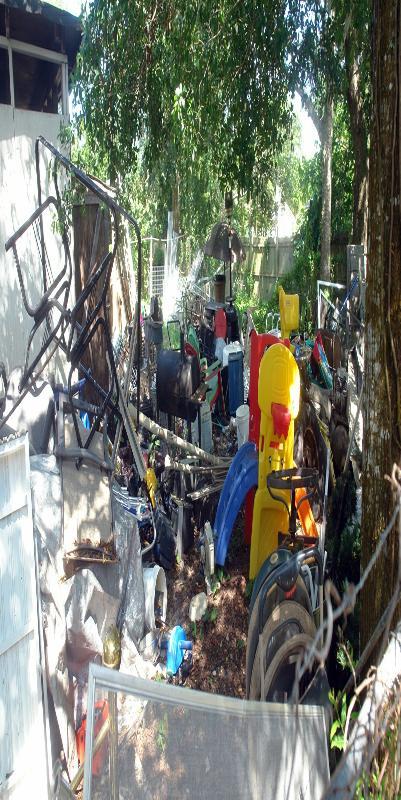 Cluttered backyard full of mosquito breeding sites